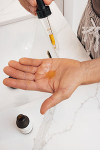 Face serum dropper into hand